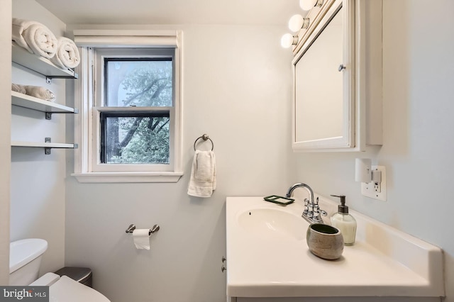 bathroom featuring toilet and vanity
