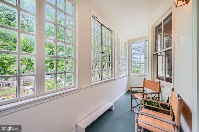 sunroom with wood finished floors and baseboards