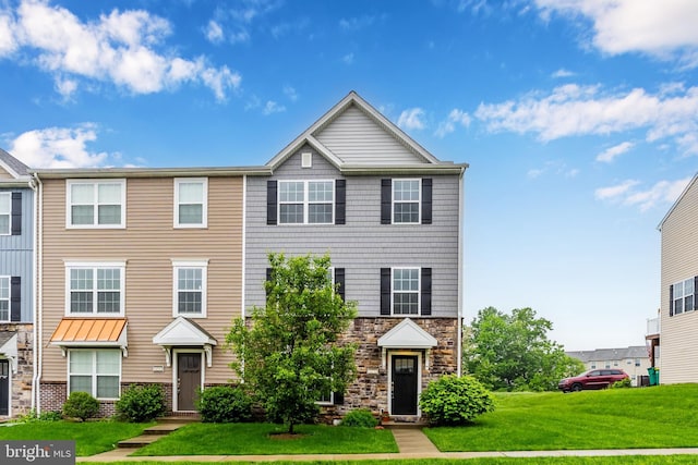 4270 Wild Orchid Ln, Enola, PA 17025 - townhome / multi-family property with a front lawn and stone siding