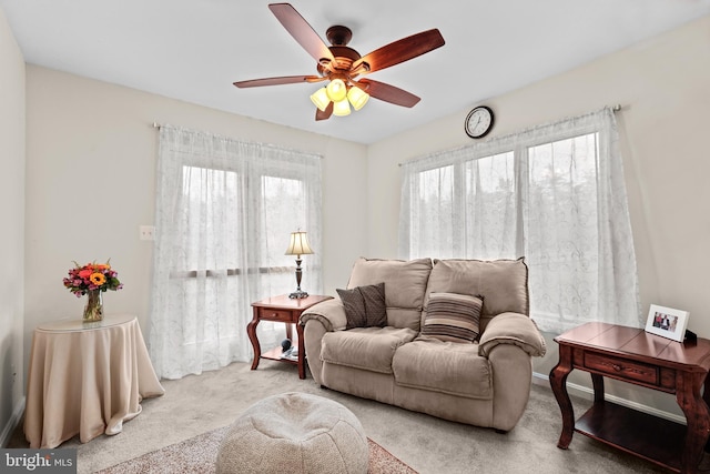 living room featuring ceiling fan and carpet