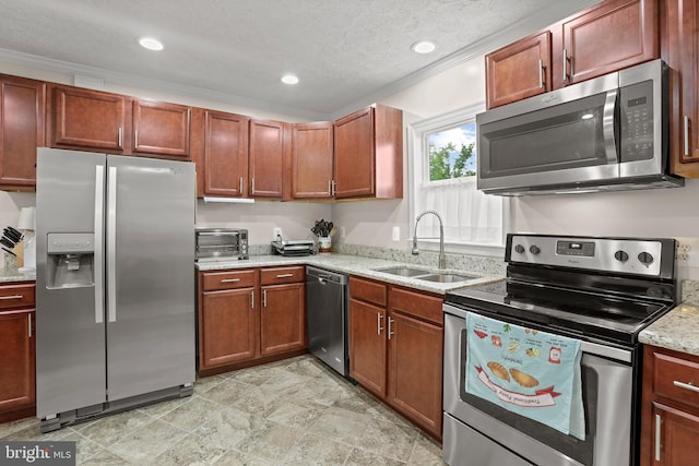 kitchen with appliances with stainless steel finishes, a sink, light stone countertops, ornamental molding, and recessed lighting