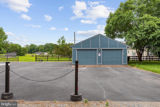 detached garage featuring fence