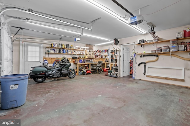 garage with a workshop area and a garage door opener