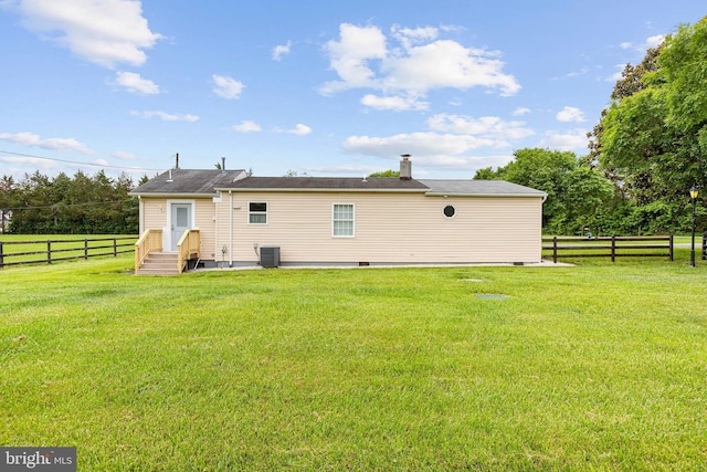 rear view of property featuring central AC and crawl space