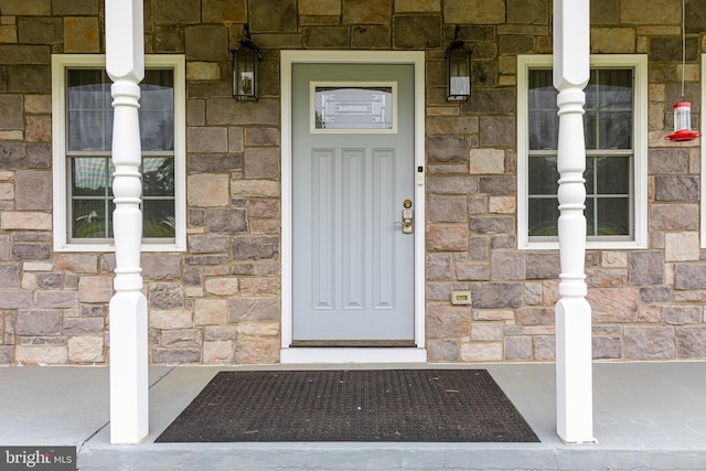 view of exterior entry featuring stone siding