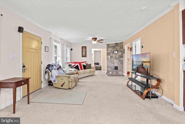 living room with light carpet, crown molding, ceiling fan, baseboards, and a textured ceiling