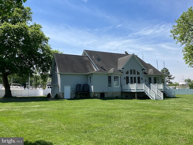 rear view of property with roof with shingles, a wooden deck, and stairs