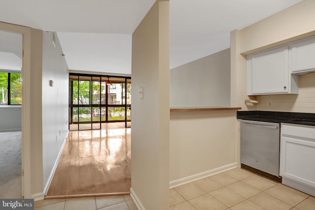 1001 N Randolph St Unit 109, Arlington, VA 22201 - kitchen featuring dishwasher, healthy amount of natural light, white cabinets, and tasteful backsplash