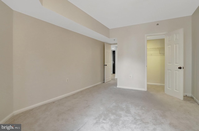 1001 N Randolph St Unit 109, Arlington, VA 22201 - unfurnished bedroom with light colored carpet, a spacious closet, baseboards, and a closet
