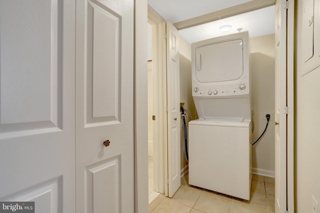 1001 N Randolph St Unit 109, Arlington, VA 22201 - clothes washing area featuring stacked washer and clothes dryer and light tile patterned flooring