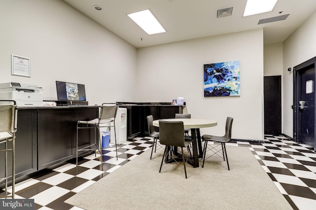 1001 N Randolph St Unit 109, Arlington, VA 22201 - dining space featuring light floors, baseboards, and vaulted ceiling