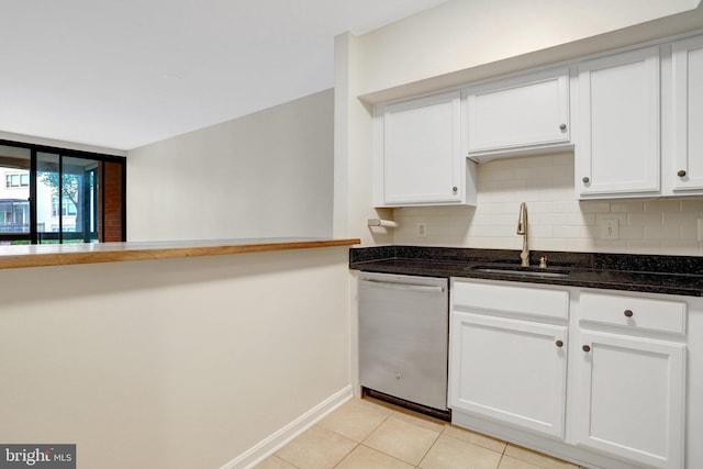 1001 N Randolph St Unit 109, Arlington, VA 22201 - kitchen with stainless steel dishwasher, a sink, decorative backsplash, light tile patterned flooring, and dark stone counters
