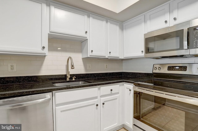 1001 N Randolph St Unit 109, Arlington, VA 22201 - kitchen featuring stainless steel appliances, a sink, white cabinets, decorative backsplash, and dark stone counters