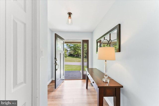 foyer featuring light wood-type flooring and baseboards
