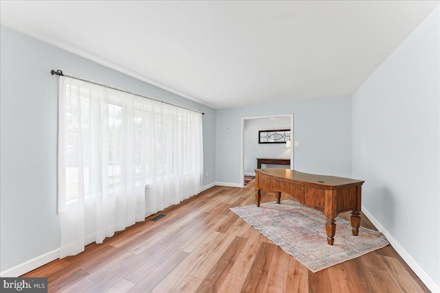 office space featuring light wood-style flooring and baseboards