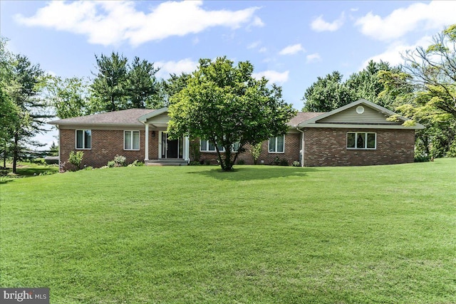 ranch-style home with a front lawn and brick siding