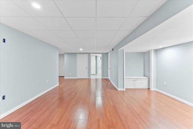basement featuring light wood-type flooring, baseboards, and recessed lighting