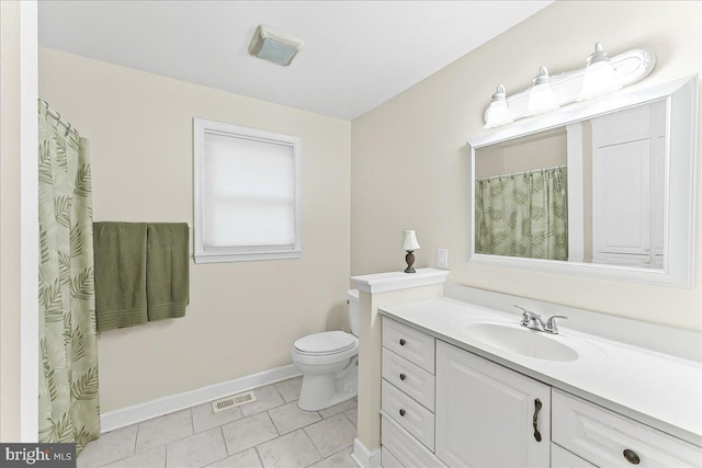 full bath featuring baseboards, toilet, vanity, and tile patterned flooring