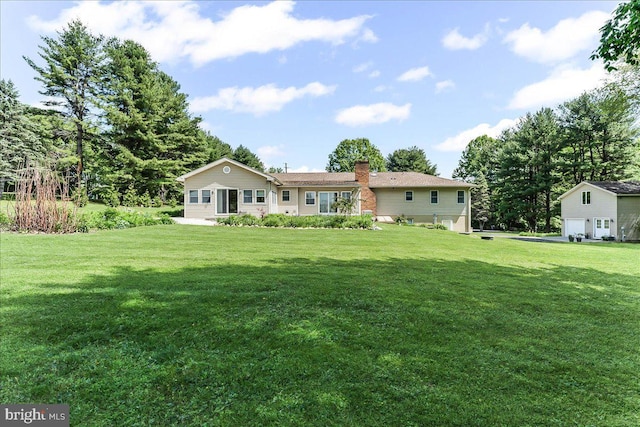 back of property with a yard and a chimney