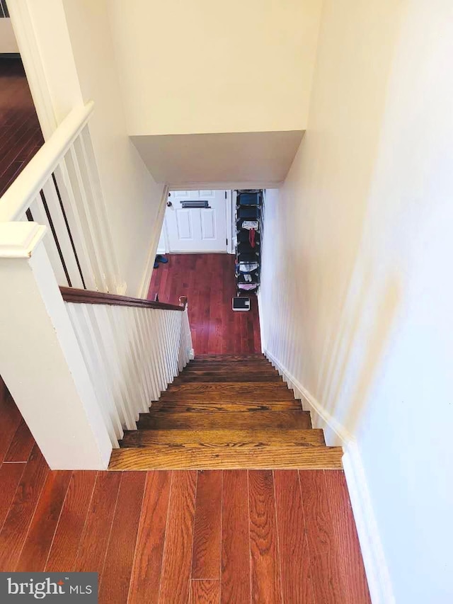 stairway featuring hardwood / wood-style floors