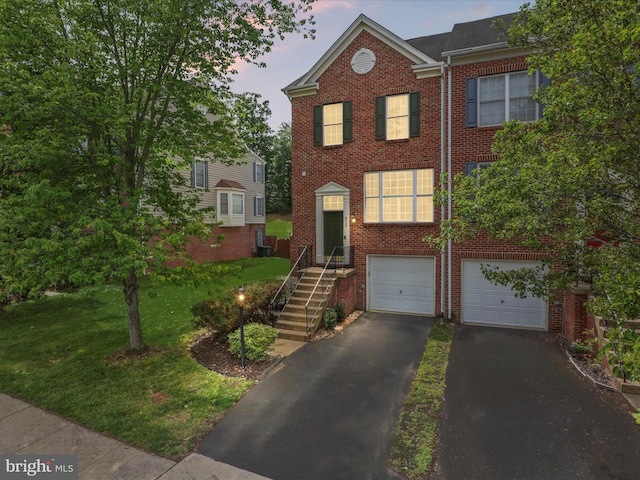 9757 Cheshire Ridge Cir, Manassas, VA 20110 - view of front facade with driveway, brick siding, an attached garage, a front yard, and cooling unit