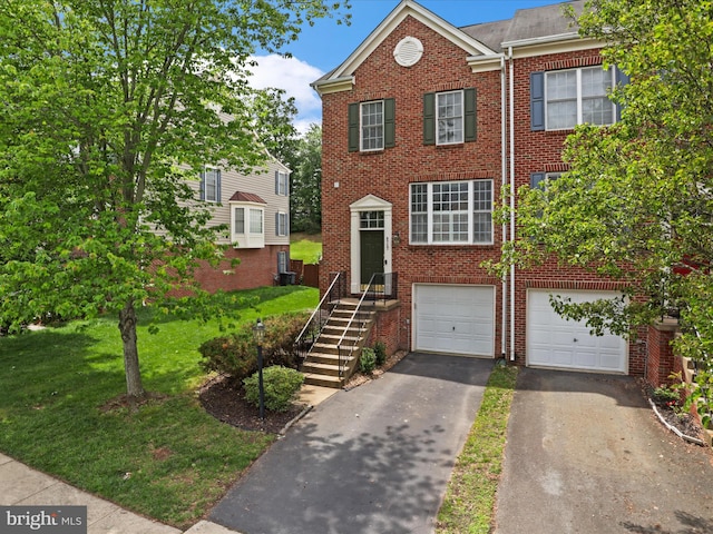 9757 Cheshire Ridge Cir, Manassas, VA 20110 - view of front facade with driveway, brick siding, a garage, a front yard, and central AC