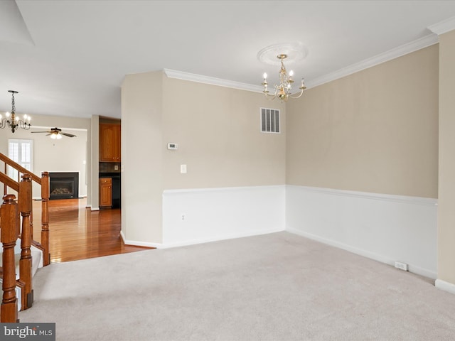 9757 Cheshire Ridge Cir, Manassas, VA 20110 - carpeted empty room with a chandelier, a fireplace, baseboards, ornamental molding, and stairs