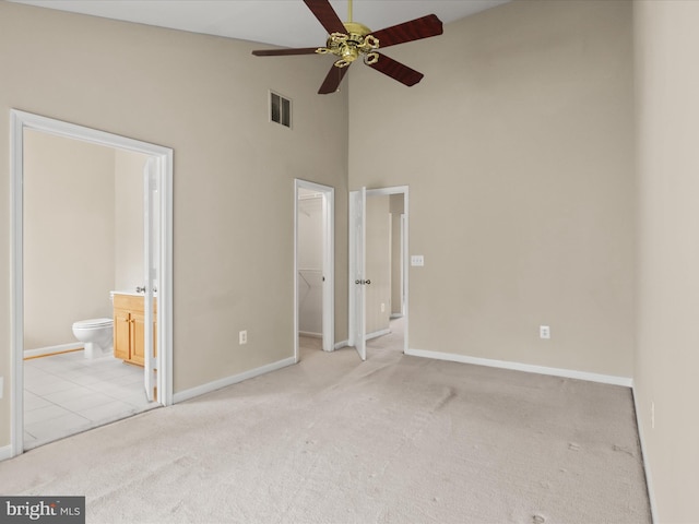 9757 Cheshire Ridge Cir, Manassas, VA 20110 - unfurnished bedroom featuring a spacious closet, carpet floors, baseboards, high vaulted ceiling, and ensuite bath