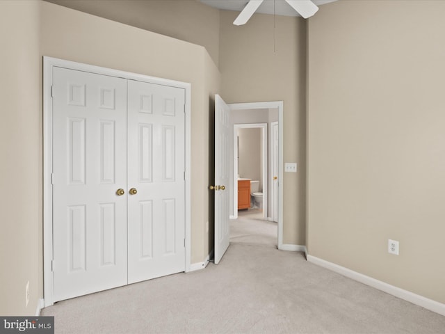 9757 Cheshire Ridge Cir, Manassas, VA 20110 - unfurnished bedroom with light carpet, a closet, baseboards, and a ceiling fan