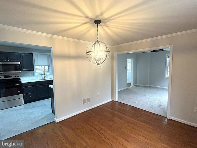 147 W Broad St, Telford, PA 18969 - unfurnished dining area featuring a sink, a chandelier, ornamental molding, wood finished floors, and baseboards