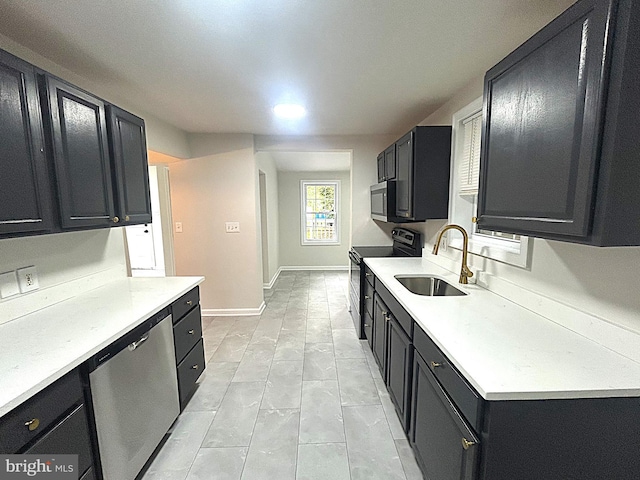 147 W Broad St, Telford, PA 18969 - kitchen with stainless steel appliances, dark cabinetry, a sink, and light countertops