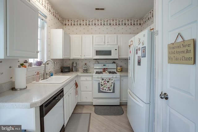 4 Montclair Ave, Berlin, NJ 08009 - kitchen with white appliances, a sink, plenty of natural light, and white cabinetry