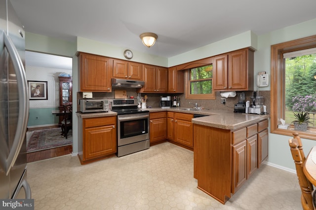 2 Wicklow Dr, Tabernacle, NJ 08088 - kitchen featuring appliances with stainless steel finishes, under cabinet range hood, brown cabinets, a sink, and plenty of natural light