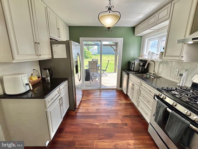 2817 Comly Rd, Philadelphia, PA 19154 - kitchen featuring stainless steel appliances, dark countertops, a sink, dark wood finished floors, and healthy amount of natural light