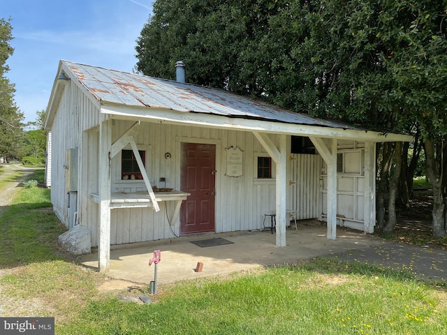 5110 Berclair Plantation Ln, Fredericksburg, VA 22408 - view of front of house with board and batten siding, an outbuilding, a front lawn, and metal roof
