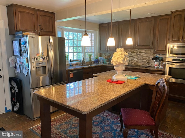 5110 Berclair Plantation Ln, Fredericksburg, VA 22408 - kitchen with stainless steel appliances, a sink, light stone counters, decorative backsplash, and hanging light fixtures