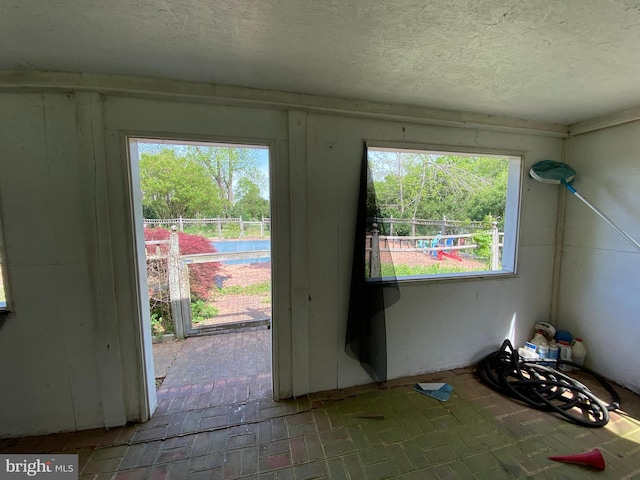 5110 Berclair Plantation Ln, Fredericksburg, VA 22408 - doorway featuring a textured ceiling and brick flooring