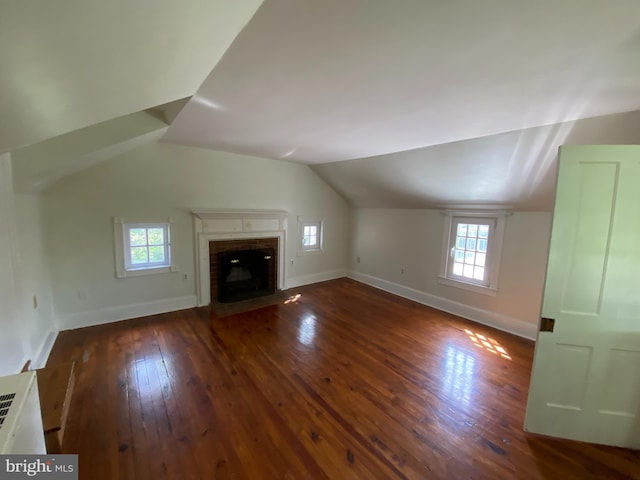 5110 Berclair Plantation Ln, Fredericksburg, VA 22408 - unfurnished living room with hardwood / wood-style flooring, healthy amount of natural light, vaulted ceiling, a brick fireplace, and baseboards