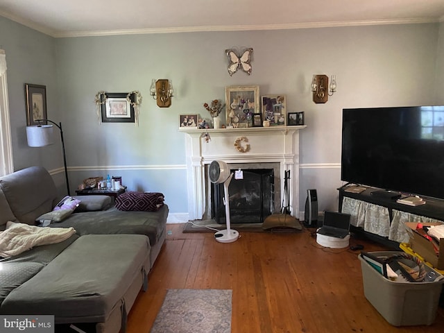 5110 Berclair Plantation Ln, Fredericksburg, VA 22408 - living area featuring hardwood / wood-style flooring, ornamental molding, a fireplace with raised hearth, and baseboards