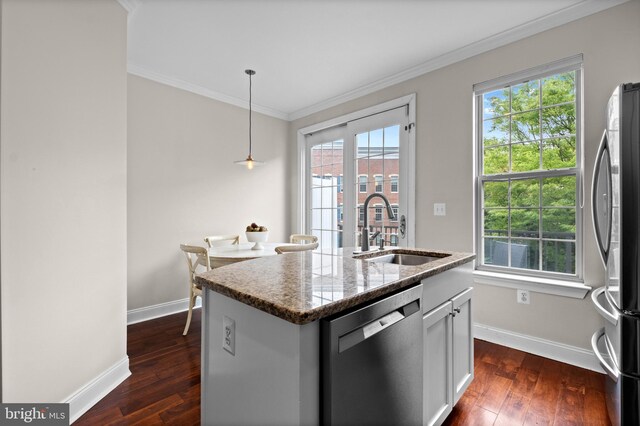 507 Governors Ct, Philadelphia, PA 19146 - kitchen with stainless steel appliances, a sink, baseboards, ornamental molding, and dark wood-type flooring