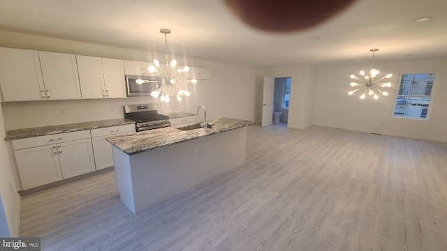 1401 Brown St Unit A, Wilmington, DE 19805 - kitchen featuring stainless steel range with gas cooktop, a chandelier, a sink, and light wood finished floors