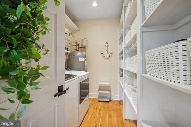 laundry room featuring washing machine and dryer, light wood-type flooring, baseboards, and recessed lighting