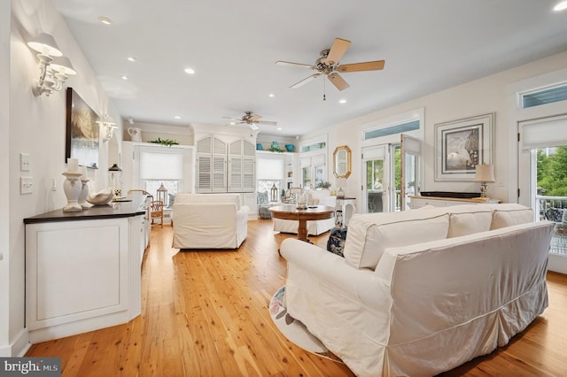 living room featuring ceiling fan, light wood finished floors, and recessed lighting