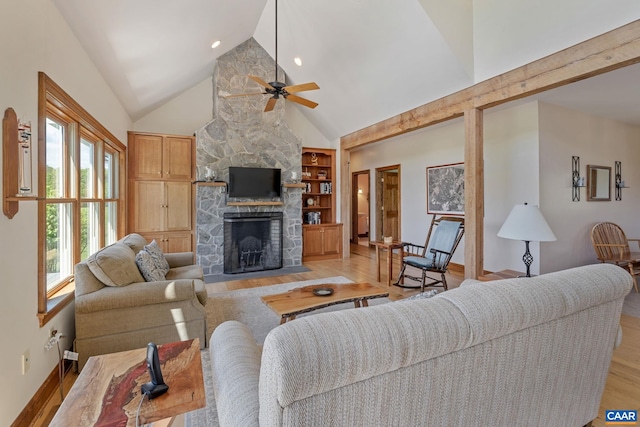 6670 Scottsville Rd, Scottsville, VA 24590 - living area with light wood finished floors, a ceiling fan, high vaulted ceiling, baseboards, and a fireplace