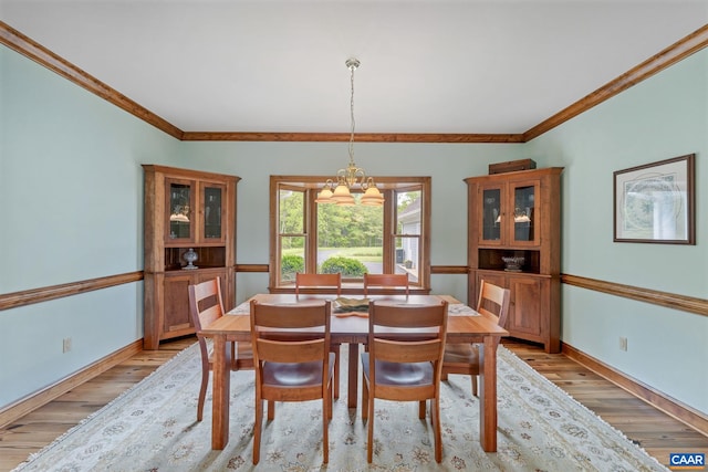 6670 Scottsville Rd, Scottsville, VA 24590 - dining area with a chandelier, light wood finished floors, ornamental molding, and baseboards