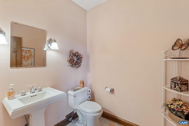 6670 Scottsville Rd, Scottsville, VA 24590 - half bath with toilet, a sink, tile patterned floors, and baseboards
