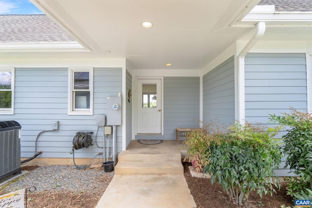 6670 Scottsville Rd, Scottsville, VA 24590 - view of exterior entry with roof with shingles and central AC
