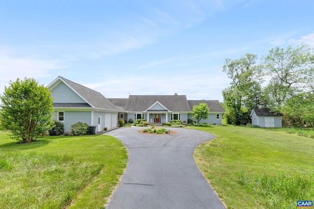 6670 Scottsville Rd, Scottsville, VA 24590 - ranch-style house with a garage, driveway, a front lawn, an outdoor structure, and a storage unit
