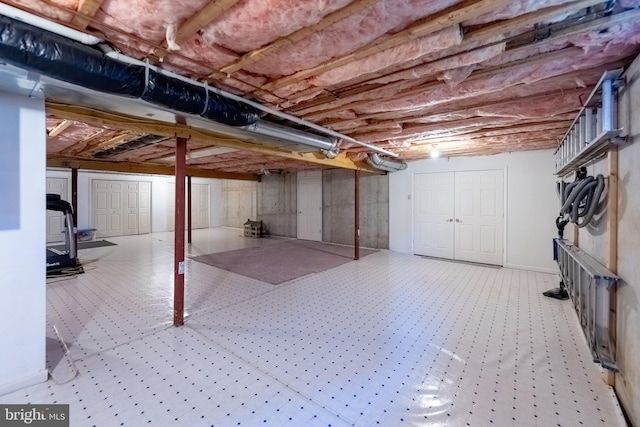 unfinished below grade area with a wood stove