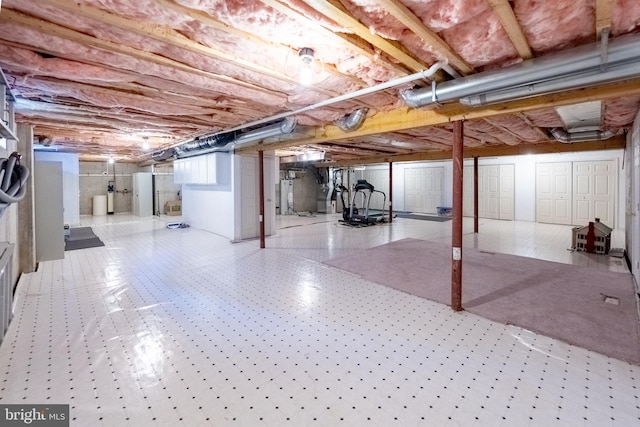 unfinished basement featuring gas water heater